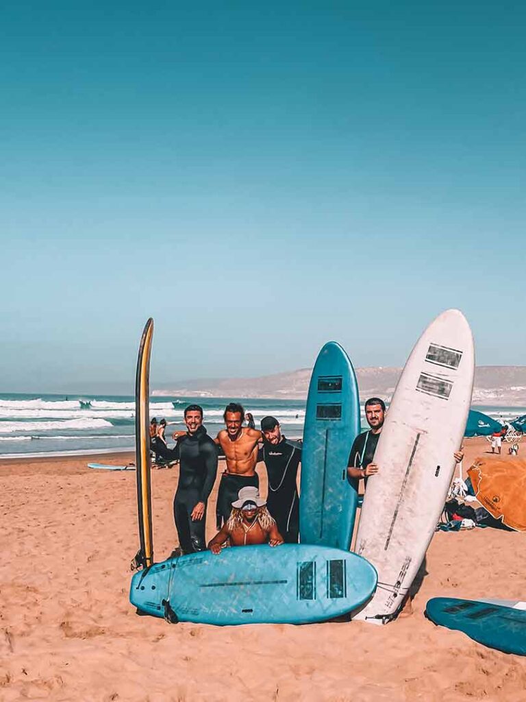 Beginner surfers having their surfboard on Tamraght beach