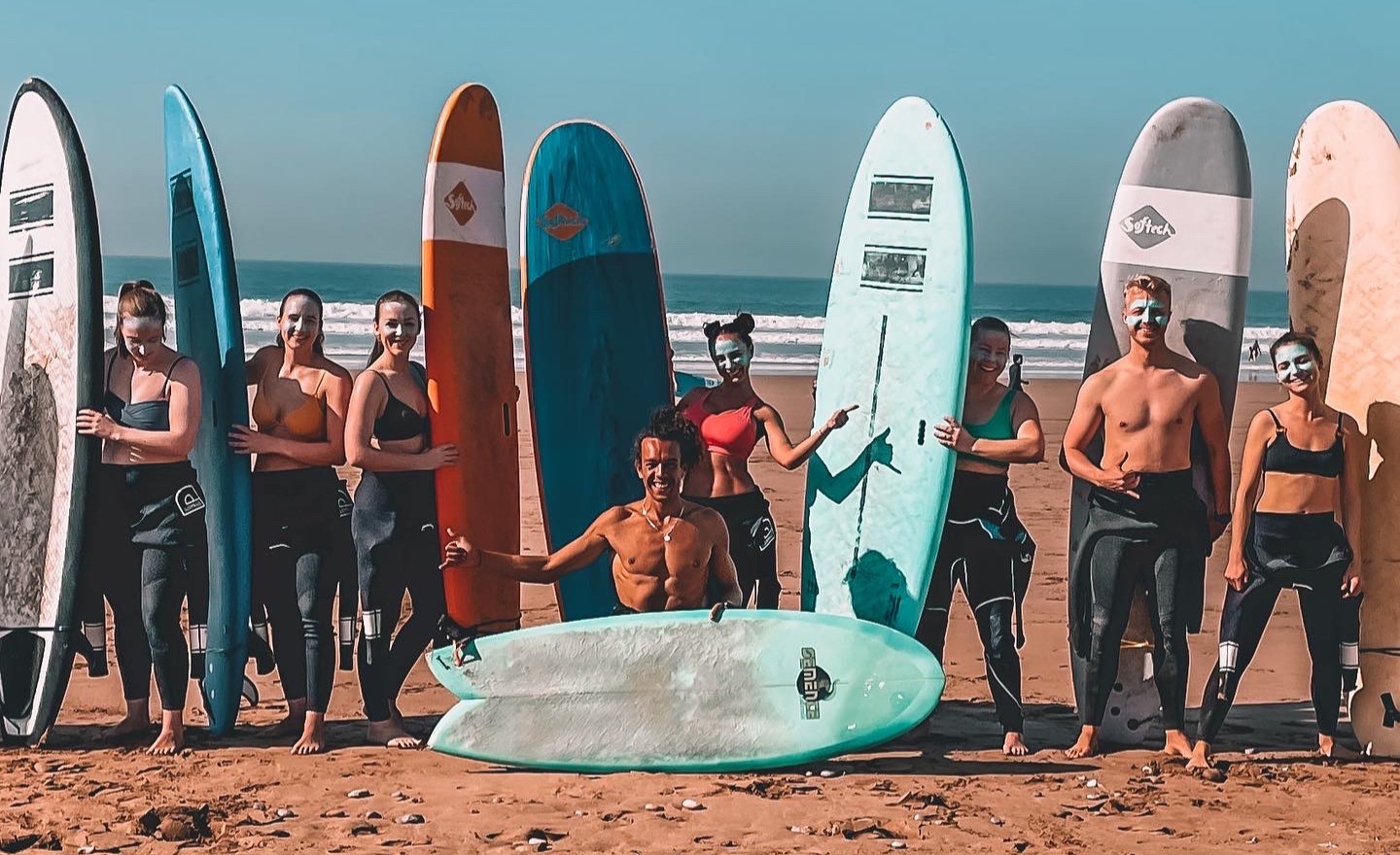 Beginners surf group picture on a beach in Tamraght after surf lesson